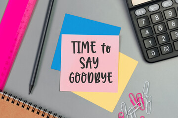 The words Time to Say Goodbye written on a sticky note paper. Closeup of a personal agenda. Top view. Conceptual photo