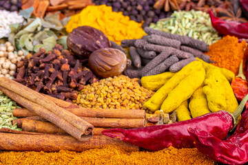 Various spices, peppers and herbs close-up top view. Eastern spice market. A set of peppers and spices for cooking.
