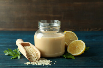 Concept of tasty food with tahini sauce on wooden table