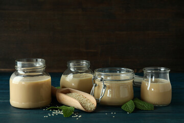Concept of tasty food with tahini sauce on wooden table