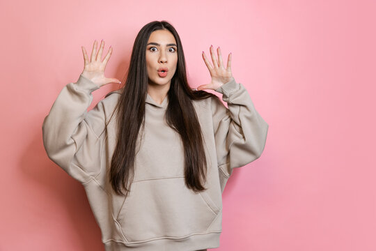 Cropped portrait of young beautiful girl with expressive fasial expression isolated over pink background. Story telling