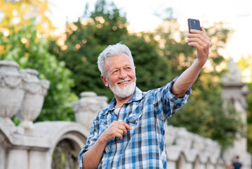 Handsome senior man taking a selfie