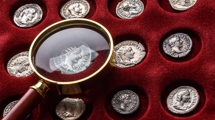 Numismatics.Authentic silver denarius, antoninianus of ancient Rome. A collector holds an old coin.Ancient coin of the Roman Empire