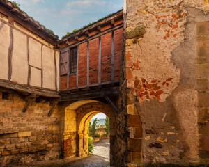 Fototapeta premium Old street and porch of the medieval village of Cordes sur Ciel, in the Tarn, in Occitanie, France