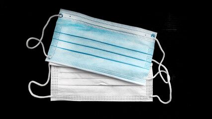 Medical mask on black background. Covid 19. Pandemic. Coronovirus. Isolation. Маска....