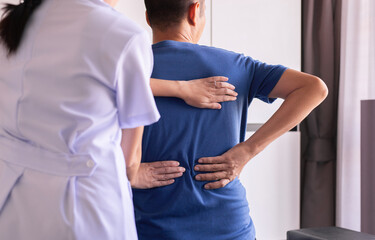 Physiotherapist woman doing treatment to man patient in clinic,Physical therapy concept