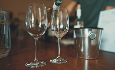 Sommelier pours a glass of wine for a tasting.