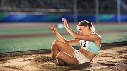 Long Jump Championship: Professional Female Athlete Land after Long Distance Jump. Determination,...