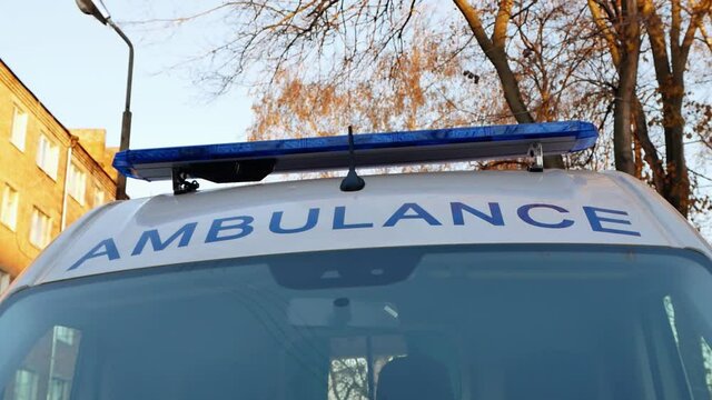 Close-up of an ambulance lettering and flashing lights on an ambulance car. 