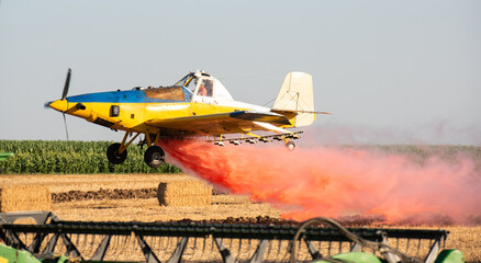 low flight of agricultural propeller plane is spraying  crop protection products.