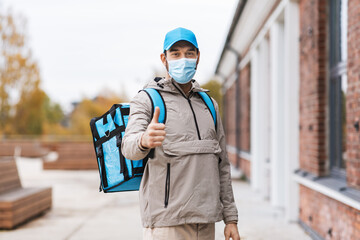 food shipping, pandemic and people concept - delivery man in protective medical mask with thermal...
