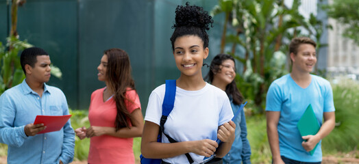 Pretty indian female student with group of multi ethnic young adults