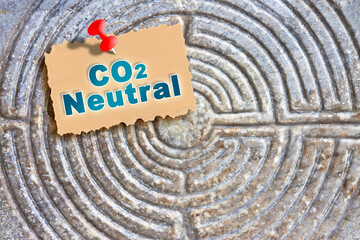 The difficulty of becoming Carbon Neutral - Strategy, problems and solutions concept with CO2 neutral against an old stone labyrinth