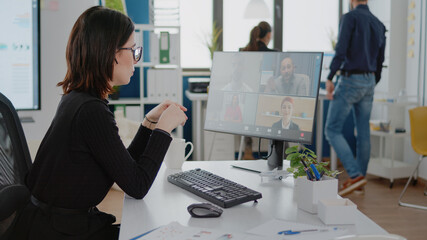 Businesswoman using video call for meeting with workmates on computer. Engineer talking to colleagues on online remote conference for business strategy and presentation planning.