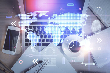 Double exposure of map hologram drawing over study table background with computer. Concept of international network. Top view.