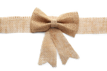 Burlap ribbon with pretty bow on white background, top view