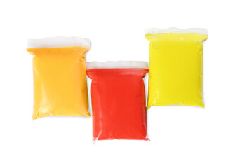 Packages of colorful play dough on white background, top view