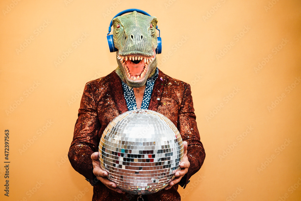 Wall mural crazy happy man dancing disco music wearing t-rex mask - party concept - focus on face