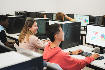 Young students using computers during business class at school - Focus on center girl face
