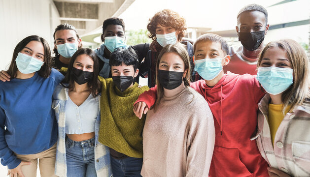 Portrait of multiracial friends wearing safety masks outside university college school - Students health care and social distance concept