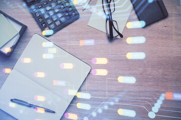 Double exposure of technology theme drawing over work table desktop. Top view. Global data analysis concept.