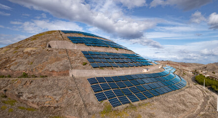 Solar panels on hill in countryside