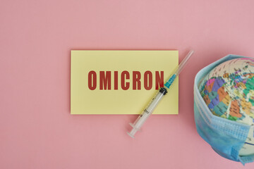 Globe in face mask and syringe. New vaccine against Covid-19 Omicron variant. Symbol of global...