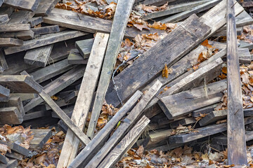 Heap of long wooden boards for the construction and improvement of the yard
