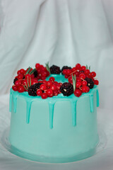 The cake is not light blue. Idea for decorating a cake. Red currants and blackberries. Cake for the holiday. Birthday. Present 