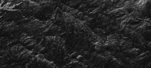 Fototapeta na wymiar Dark gray stone background with copy space. Black grunge banner with rock texture.