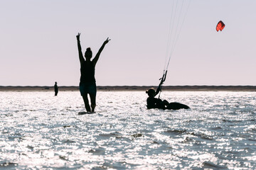 Naklejka premium Silhouette Of Happy And Excited Woman Holding Hands In The Air