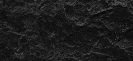 Fototapeta na wymiar Dark gray stone background with copy space. Black grunge banner with rock texture.
