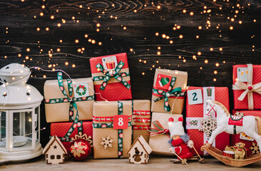 Handmade wrapped red, green gift boxes decorated with ribbons, snowflakes and numbers, Christmas decorations and decor on white table Xmas advent calendar concept Top view Flat lay Holiday card