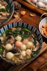 Red and white tangyuan with savory soup.
