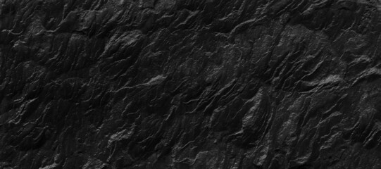 Dark gray stone background with copy space. Black grunge banner with rock texture.