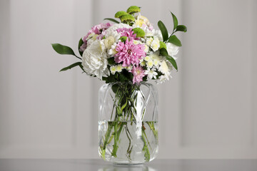 Bouquet of beautiful chrysanthemum flowers in vase on table