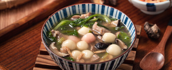 Red and white tangyuan with savory soup.