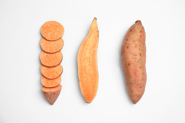 Cut and whole sweet potatoes on white background, top view