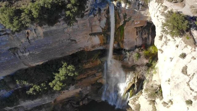 Aerial: high waterfall zoom out