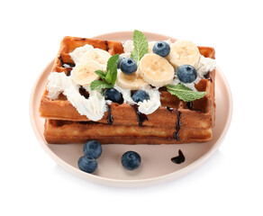 Plate of delicious Belgian waffles with blueberry, banana, whipped cream and chocolate sauce isolated on white