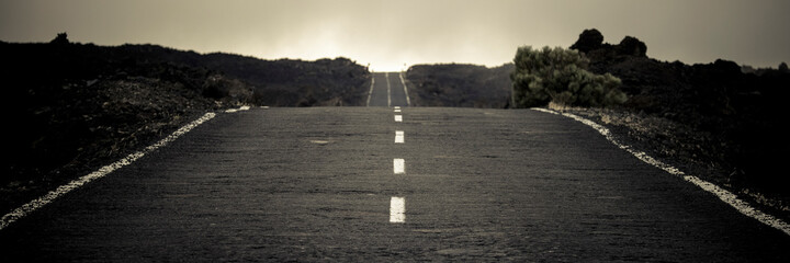 Banner header with long straight asphalt road in country side with horizon in background. Travel...
