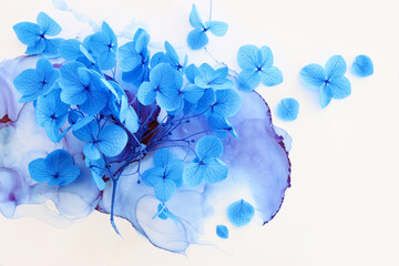 Fototapeta na wymiar Creative image of blue Hydrangea flowers on artistic ink background. Top view with copy space