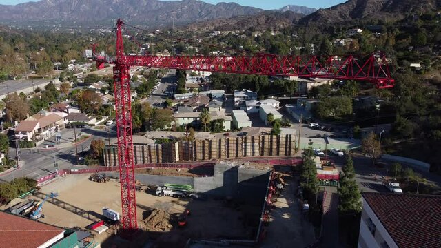 descending and tilting up shot of red construction crane