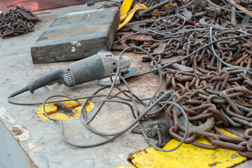 Safe cargo lashing onboard of ship deck with cargo lashing chains and tensioner.