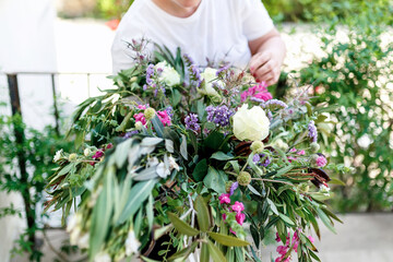 the florist collects eucalyptus branches in the composition