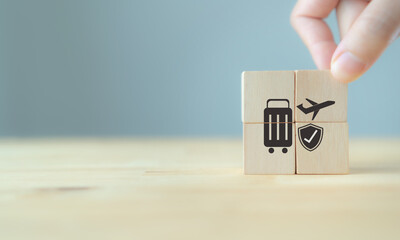 Travel safety and travel insurance concept ;wooden cube with grey background, copy space. Intended...