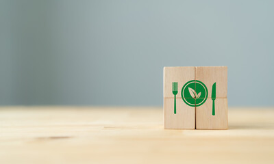Vegetarian eco green food concept. Bio, organic, vegan, fresh food  symbols on wooden cubes with beautiful grey background and copy space. Green, clean and healthy food banner.