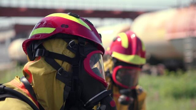 Working moment. Clip. People perform work in gas masks with dangerous explosives and smoke