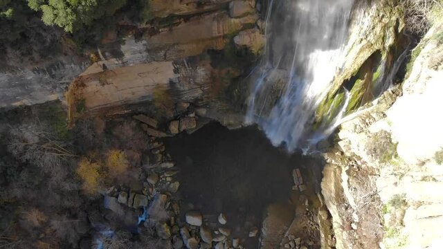 Aerial: high waterfall zoom out