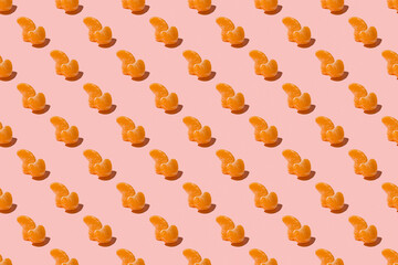 Ripe fruit tangerines. Trendy sunlight summer pattern made with mandarine slice on bright light pink background. Minimal summer concept. Seamless pattern